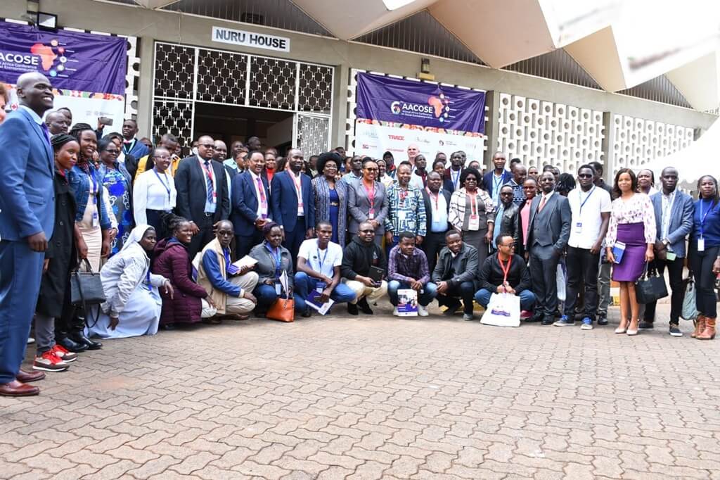 Catalyst 2030 Kenya chapter members outside the entrance to the 2023 AACOSE venue entrance